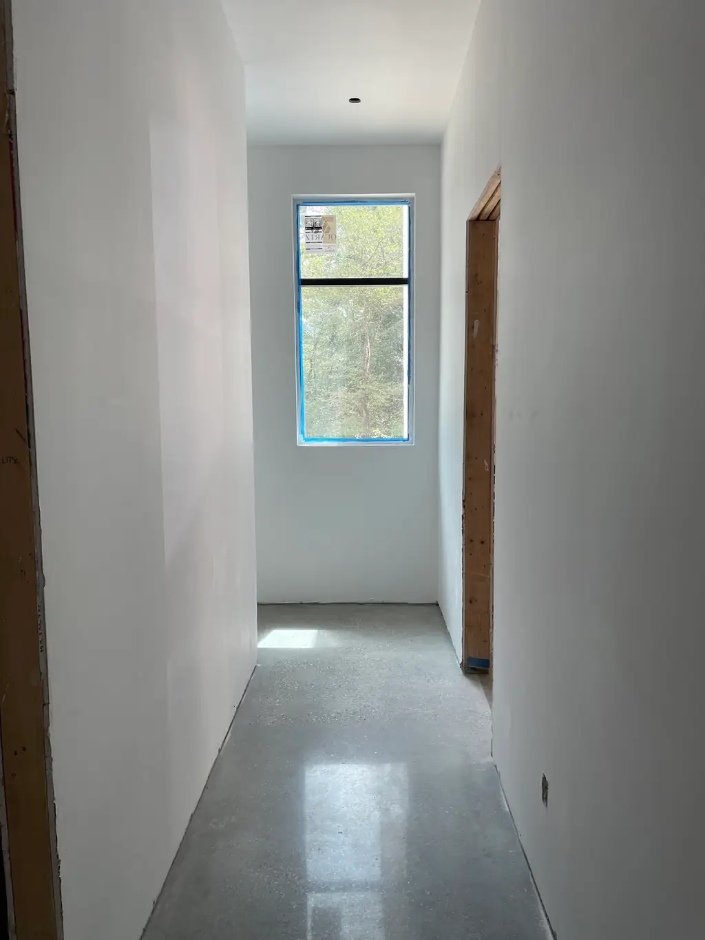 A quiet polished concrete hallway after the floor has been cleared and finished